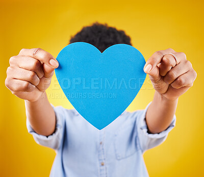 Buy stock photo Paper, heart and cover with woman in studio for romance, positive and emotion. Happiness, love shape and giving with female isolated on yellow background for date, feelings and affectionate