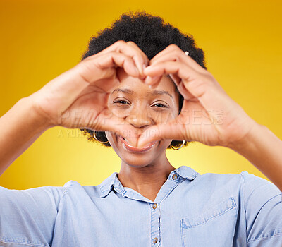 Buy stock photo Love, heart hands sign and portrait of black woman, smile and kindness isolated on yellow background. Motivation, support and loving hand gesture, happy African model in studio with caring mindset.