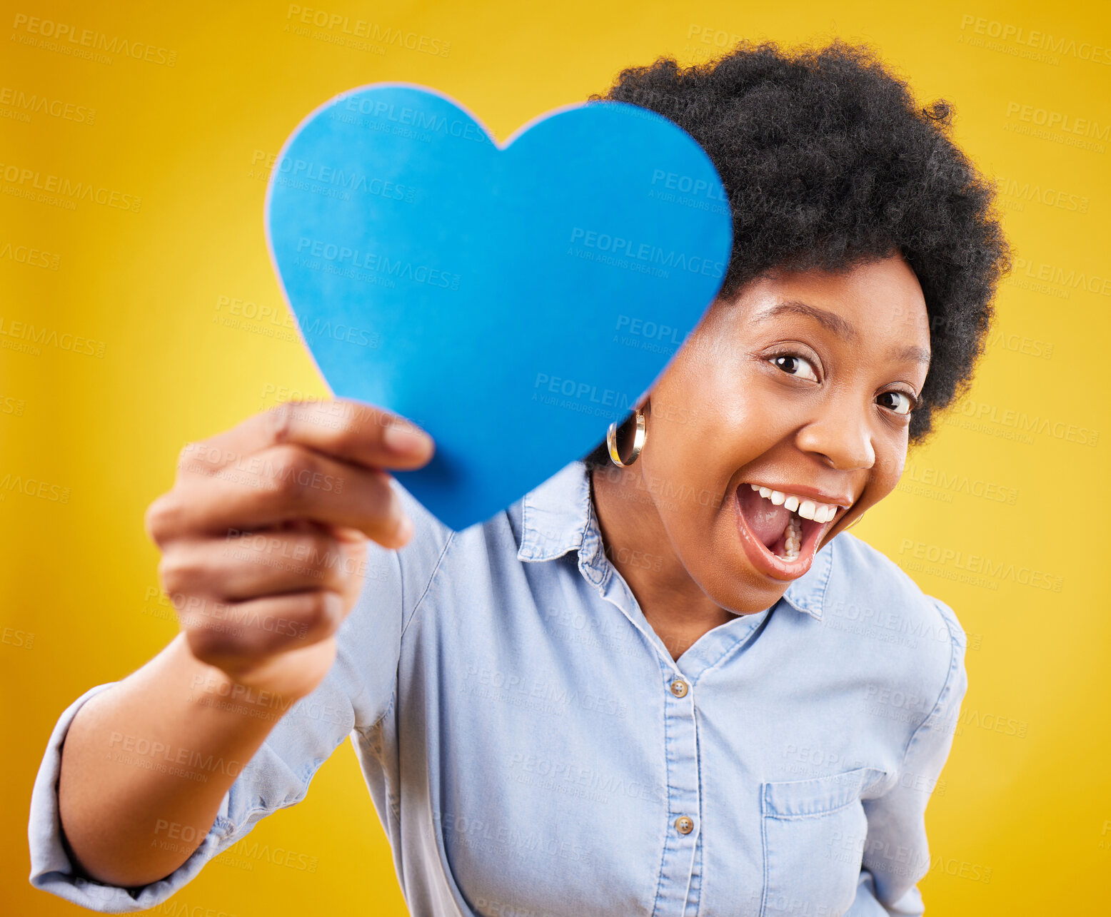 Buy stock photo Paper, heart and excited with black woman in studio for romance, positive and emotion. Happiness, love shape and giving with female isolated on yellow background for date, feelings and affectionate