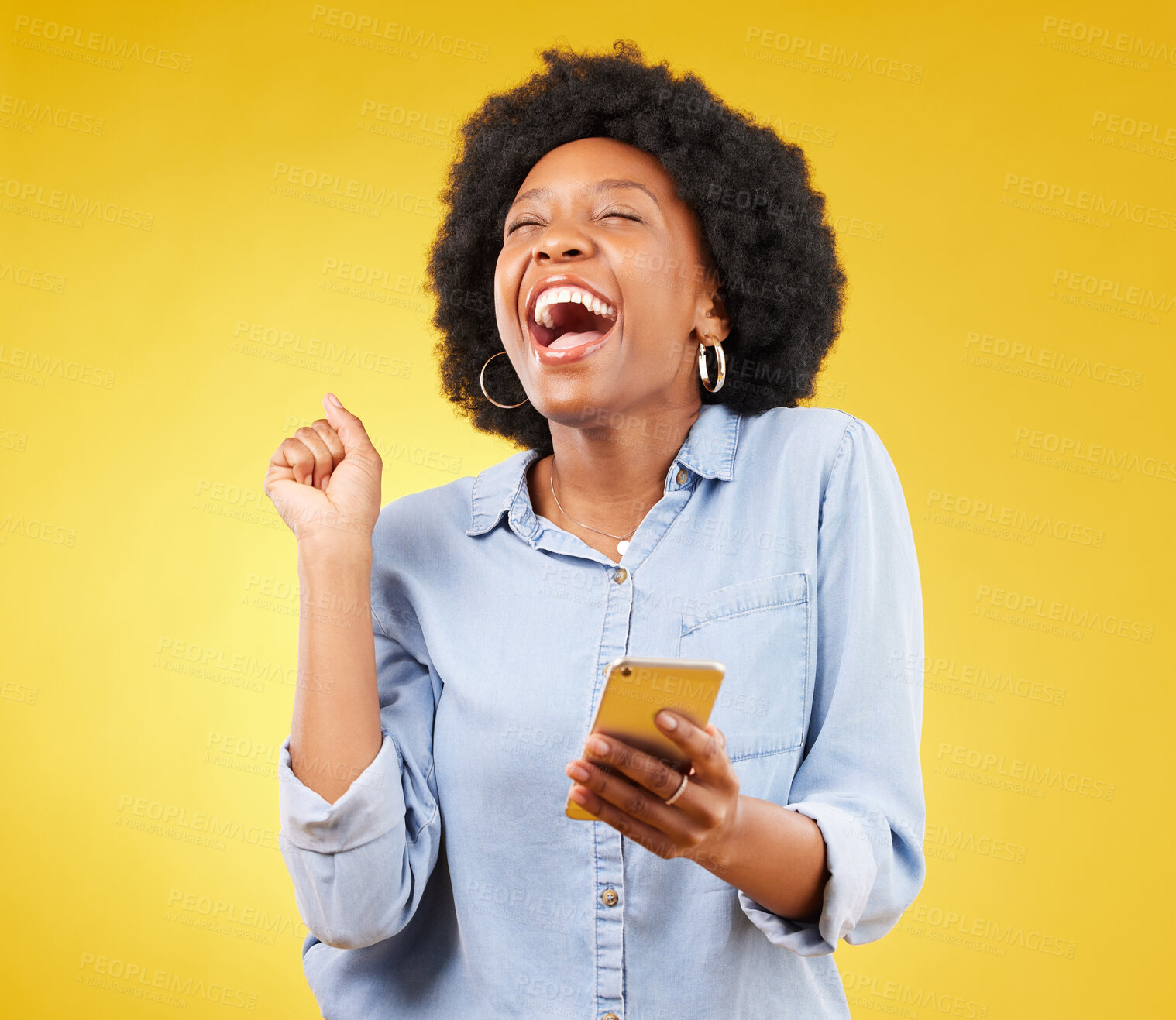 Buy stock photo Happy, excited and phone with black woman in studio for text message, notification and social media news. Deal, winner and celebration with girl on yellow background for offer, giveaway and surprise