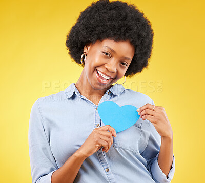 Buy stock photo Happy, paper and heart with portrait of black woman in studio for support, kindness and romance. Smile, love and emotion with female isolated on yellow background for date, feelings and happiness
