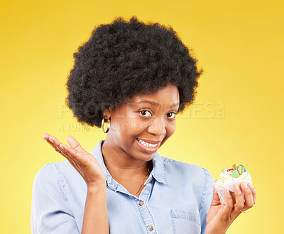 Buy stock photo Young black woman, cupcake dessert and studio with temptation, cheat diet and junk food by yellow background. African model, cake and choice for unhealthy, nutrition and sweets with meal in portrait