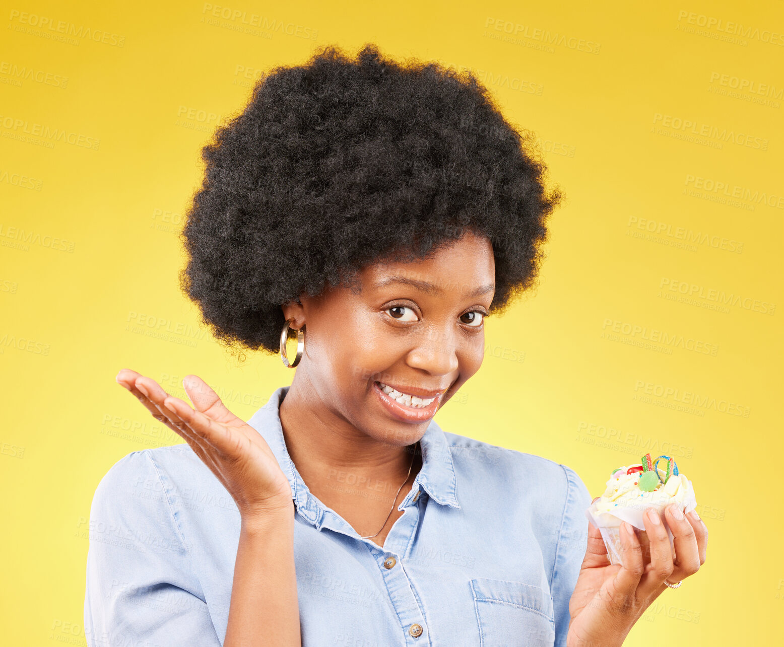 Buy stock photo Young black woman, cupcake dessert and studio with temptation, cheat diet and junk food by yellow background. African model, cake and choice for unhealthy, nutrition and sweets with meal in portrait