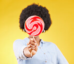 Cover, candy and lollipop with black woman in studio for colorful, cheerful and positive. Young, happiness and dessert with female isolated on yellow background for treats, food and confectionary