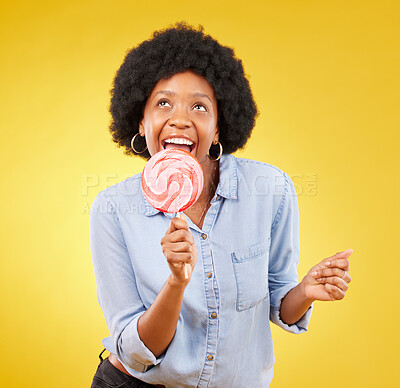 Buy stock photo Eating, candy and lollipop with black woman in studio for colorful, cheerful and positive. Young, happiness and dessert with female isolated on yellow background for treats, food and confectionary