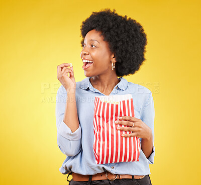 Buy stock photo Happy, eating and popcorn with black woman in studio for movie, streaming service and cinema. Television, smile and theatre with female and snack isolated on yellow background for food, tv and film