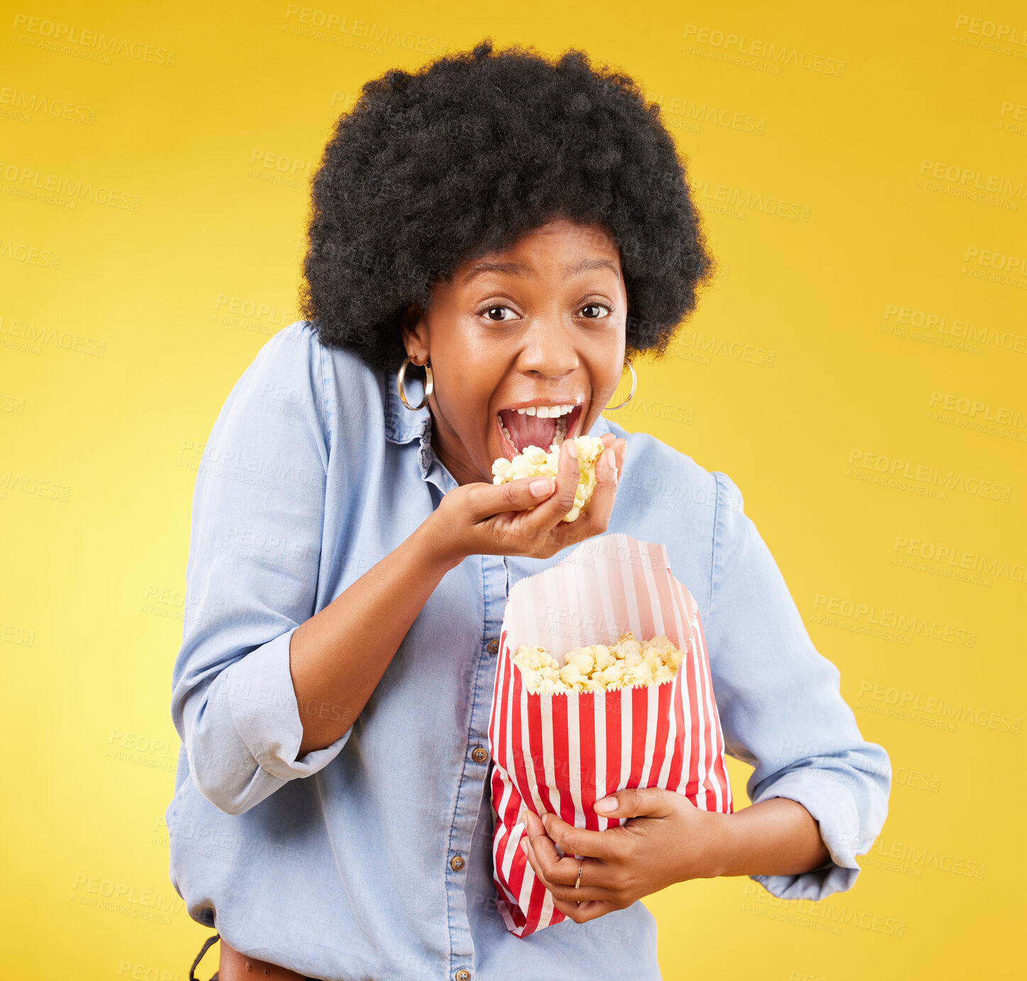 Buy stock photo Happy, food and popcorn with black woman in studio for movie, streaming service and cinema. Crazy, comedy and theatre with female and snack isolated on yellow background for eating, tv and film