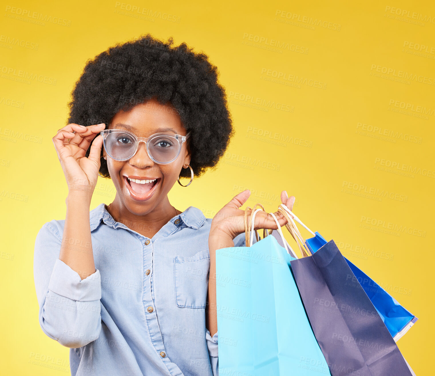 Buy stock photo Fashion, portrait and black woman with shopping bags, smile and excited for sale in studio on yellow background. Face, shopper and girl customer cheerful after boutique, retail or store discount 