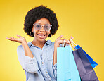 Shopping bag, retail portrait and black woman with sales product, discount fashion deal or mall store present. Commerce market, luxury designer gift and happy customer isolated on yellow background