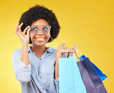 Buy stock photo Fashion, smile and black woman with shopping bags, happy and excited for sale in studio on yellow background. Sunglasses, shopper and girl customer cheerful after boutique, retail or store discount 