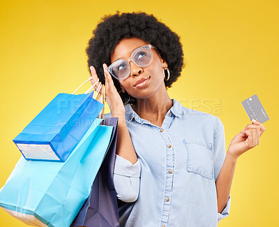 Buy stock photo Shopping bag, retail thinking or black woman with credit card for sales product, fashion deal or mall store present. Commerce market, gift idea or customer contemplating isolated on yellow background