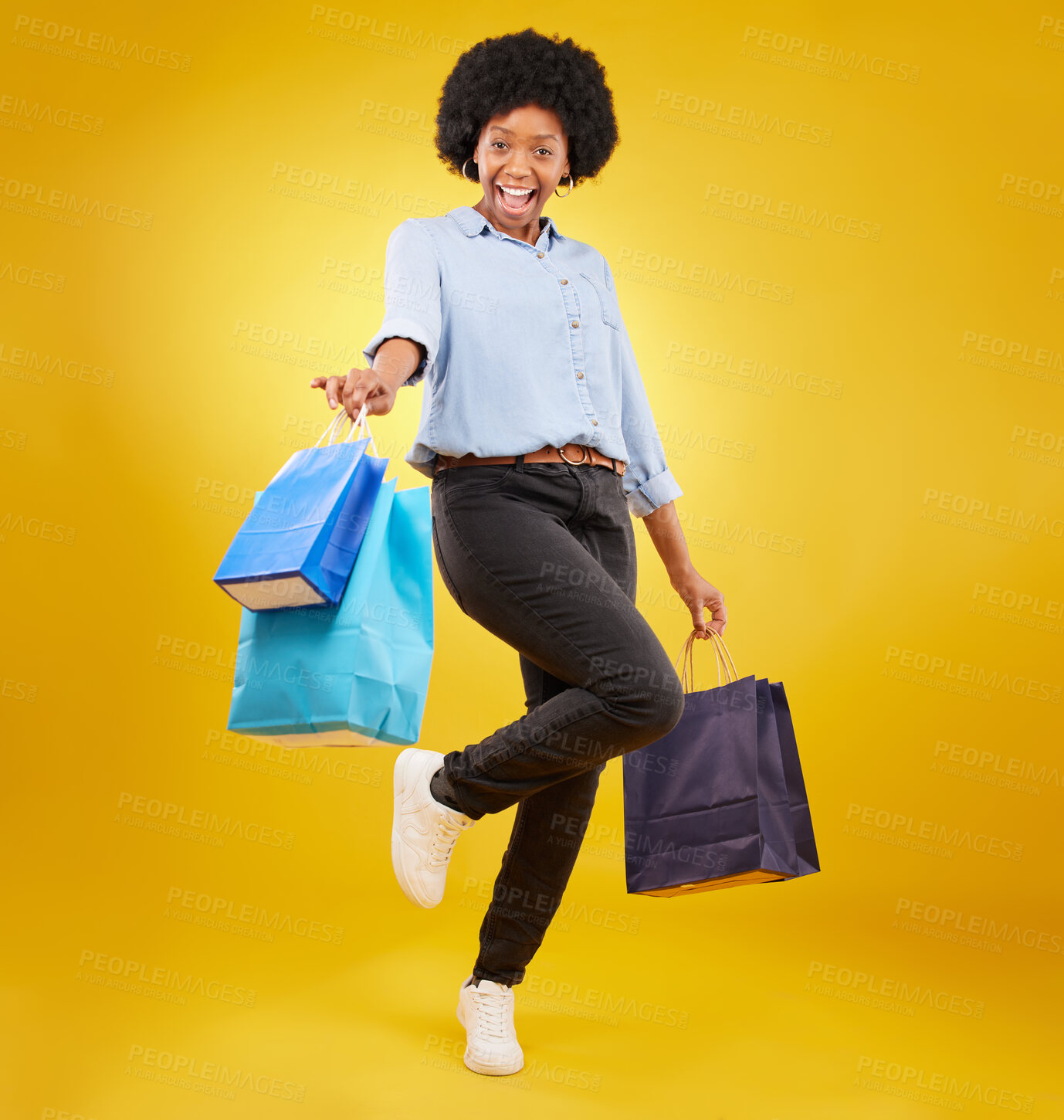 Buy stock photo Black woman with shopping bag, happy with fashion and retail in portrait on yellow studio background. Happiness, female with discount and sale at boutique with designer brand, carefree and mockup