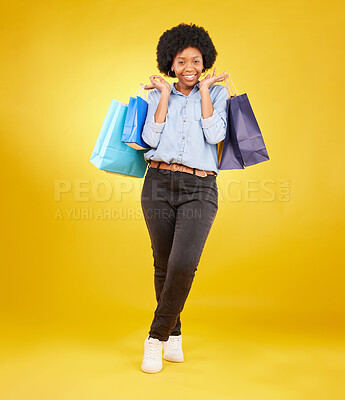 Buy stock photo Black woman with shopping bag, smile with fashion and retail in portrait on yellow studio background. Happiness, female with discount and sale at boutique with designer brand, happy and mockup space