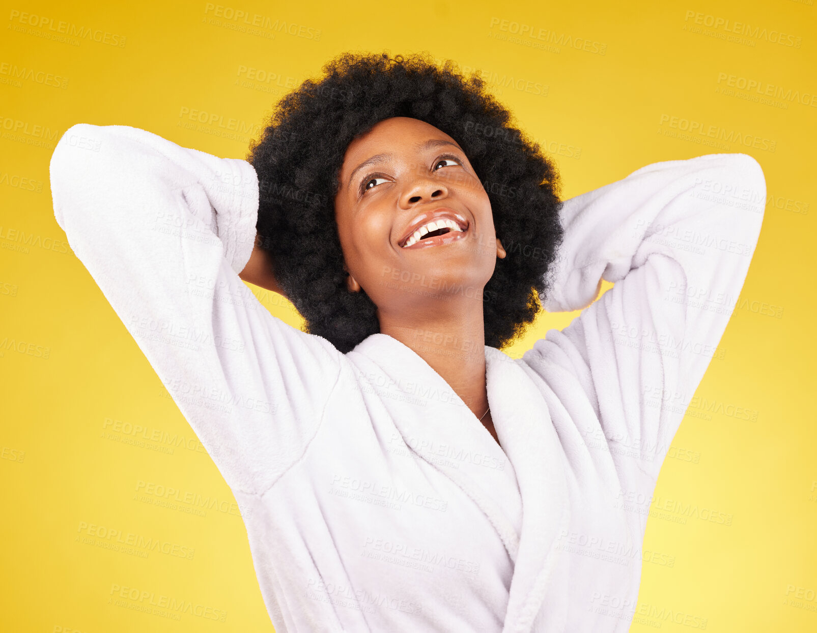 Buy stock photo Black woman relax, bathrobe and happiness in a studio ready for luxury spa treatment for self care. Isolated, yellow background and happy young female with a smile from skincare and wellness