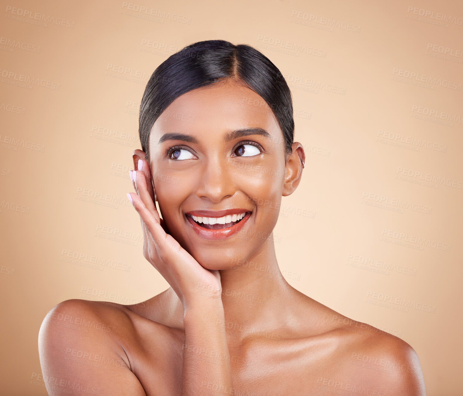 Buy stock photo Thinking face, smile or makeup on happy woman in studio isolated on beige background for natural facial skincare. Hand, beauty or beautiful young Indian girl with luxury self care or glowing results