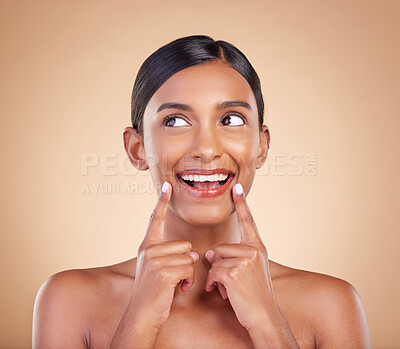 Buy stock photo Indian woman, skincare and hands for thinking in studio with face, smile and wellness by background. Young asian model, girl and cosmetics for natural skin glow, aesthetic or happiness for idea