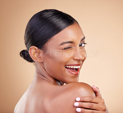 Buy stock photo Indian woman, beauty and skincare portrait with wink, smile and looking over shoulder with wellness. Young asian model, comic gen z girl and cosmetics for natural skin glow, aesthetic and happiness