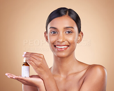 Buy stock photo Portrait, beauty and antiaging serum with a model woman in studio on a beige background to promote skincare. Face, product and collagen with an attractive young female posing for luxury cosmetics