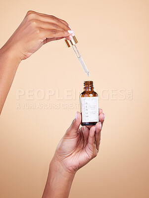 Buy stock photo Hands, serum and pipette with bottle product in studio isolated on brown background. Skincare, dermatology and woman model with cruelty free hyaluronic acid, vegan retinol or essential oil cosmetics.