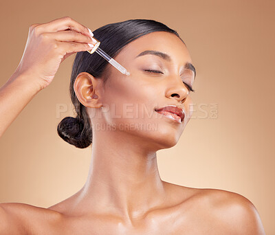 Buy stock photo Woman, dropper and retinol on face for skincare beauty or cosmetics against a studio background. Beautiful female with pipette applying oil drop to skin for hydration, moisturizer or facial treatment