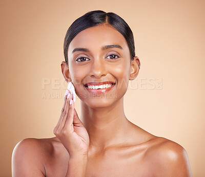 Buy stock photo Portrait, beauty and cotton swab with a model woman in studio on a beige background to promote skincare. Face, skin and exfoliate with an attractive young female posing for luxury cosmetics