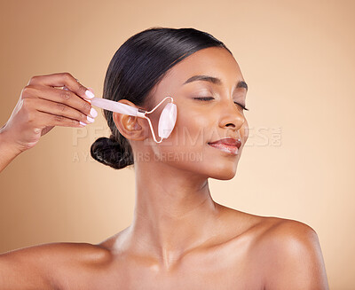 Buy stock photo Woman, roller and face for skincare beauty, cosmetics or dermatology and anti aging against a studio background. Happy female model rolling skin for facial treatment, natural health and wellness