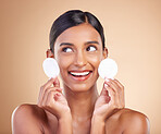 Smile, happy or woman with cotton pad in studio isolated on beige background for facial skincare. Face headshot, natural beauty or beautiful young Indian girl with luxury self care or glowing results