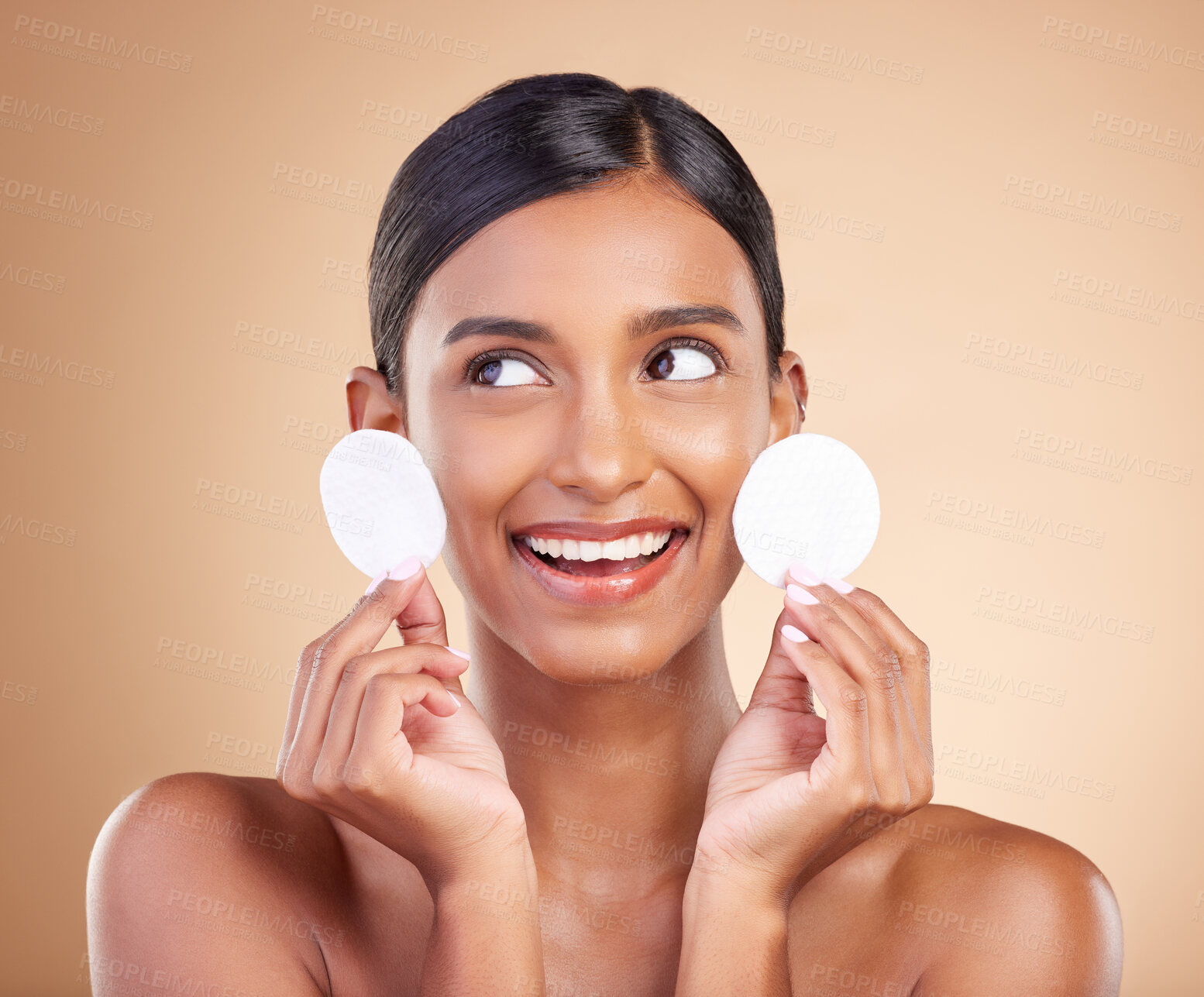 Buy stock photo Smile, happy or woman with cotton pad in studio isolated on beige background for facial skincare. Face headshot, natural beauty or beautiful young Indian girl with luxury self care or glowing results