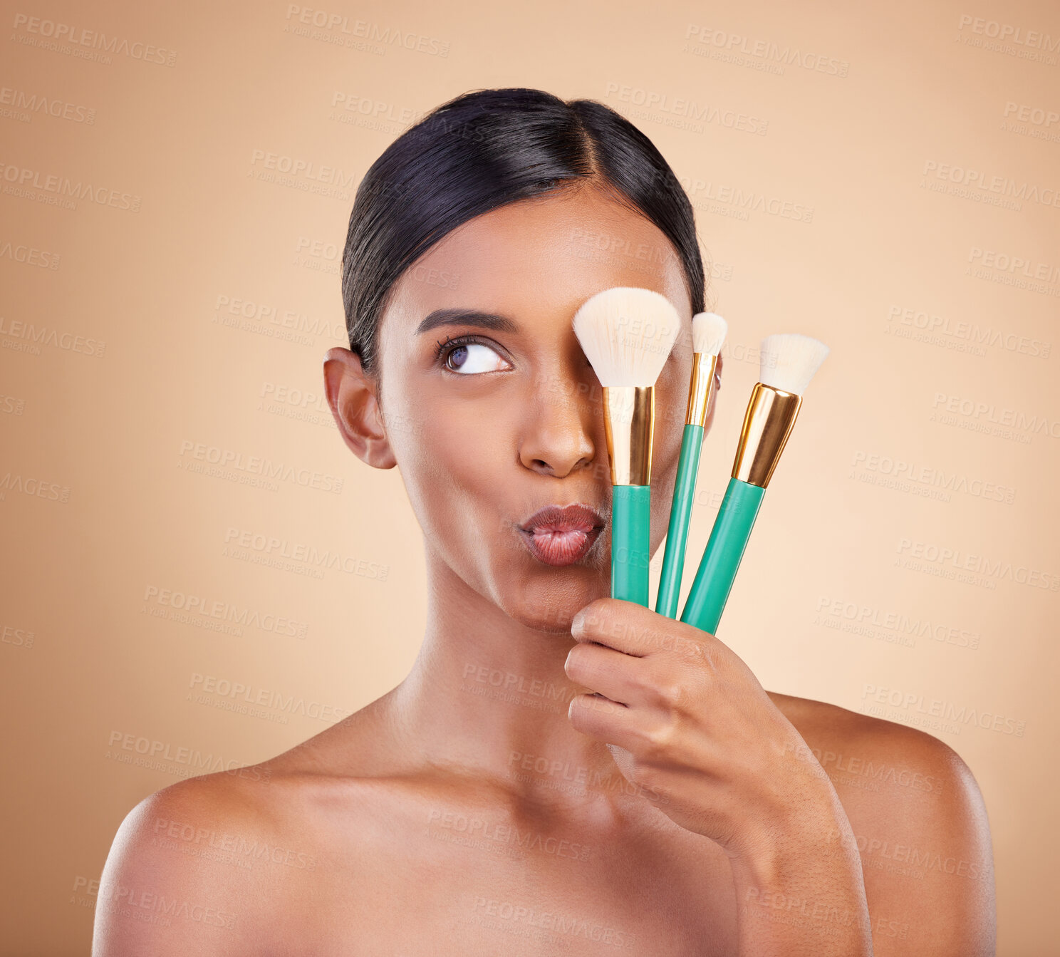 Buy stock photo Skincare, brush and Indian woman with makeup, foundation and funny on brown studio background. Female, lady or cosmetics tools with glamour, elegant or beauty for luxury grooming or facial expression