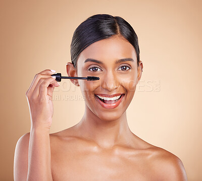 Buy stock photo Portrait, beauty and mascara with a model woman in studio on a beige background to promote makeup. Face, eye and product with an attractive young female posing for cosmetics or luxury wellness