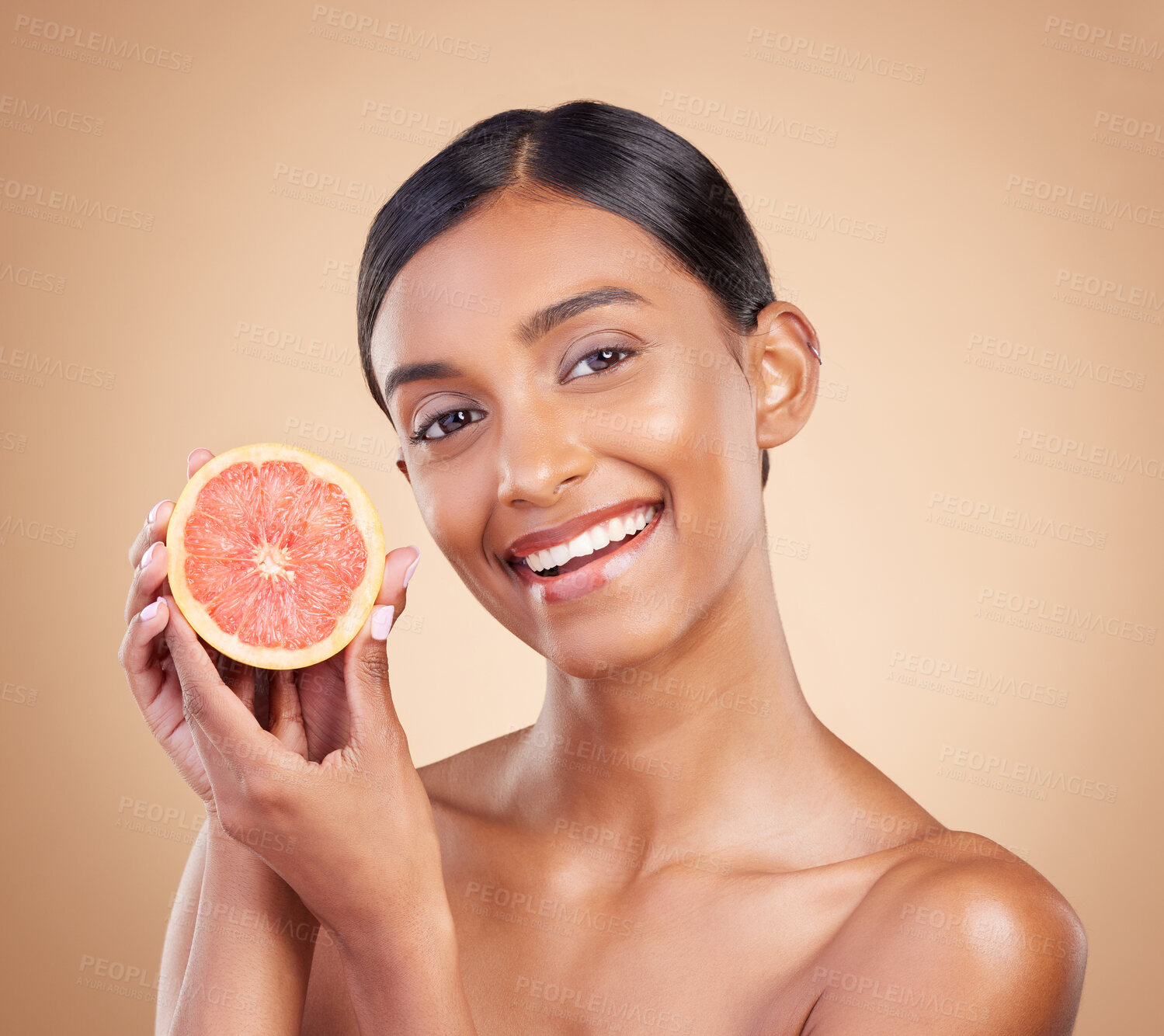 Buy stock photo Portrait, skincare and grapefruit with a model woman in studio on a beige background to promote beauty. Face, fruit and natural with an attractive young female posing for organic or luxury cosmetics