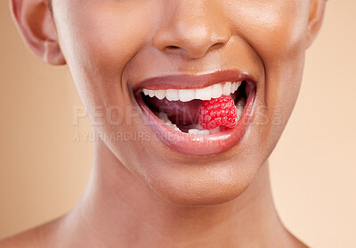 Buy stock photo Woman, mouth and raspberry for skincare nutrition, dermatology or diet health plan against a studio background. Female lips with fruit for natural organic food, self care or eat for healthy wellness