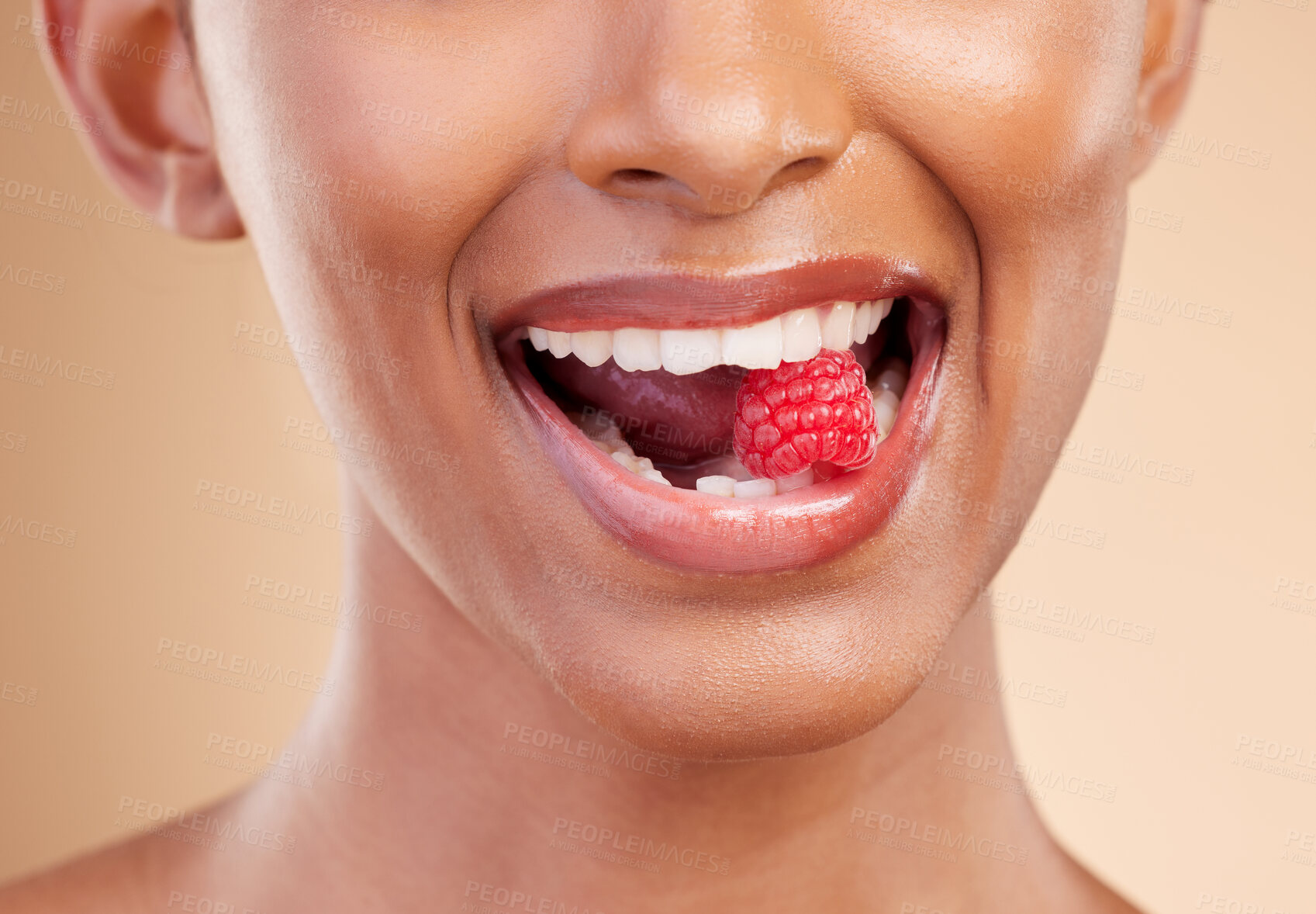 Buy stock photo Woman, mouth and raspberry for skincare nutrition, dermatology or diet health plan against a studio background. Female lips with fruit for natural organic food, self care or eat for healthy wellness