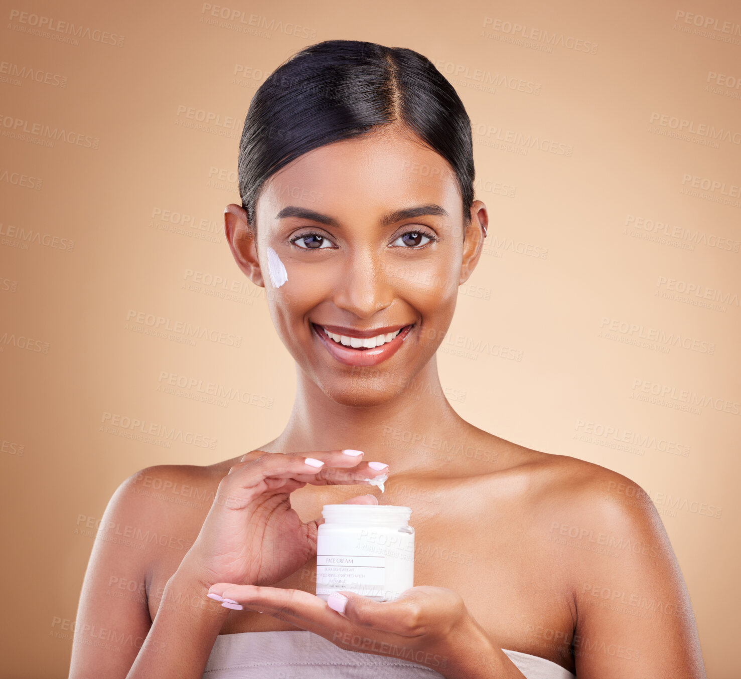 Buy stock photo Portrait, product and cream with a model woman in studio on a beige background for beauty or skincare. Face, advertising and lotion with an attractive young female holding a cosmetics container