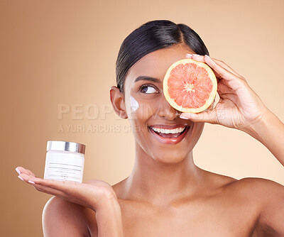 Buy stock photo Grapefruit, skincare or happy woman with cream product for beauty or young face isolated on studio background. Cosmetics, smile or Indian girl with facial moisturizer or dermatology lotion for glow