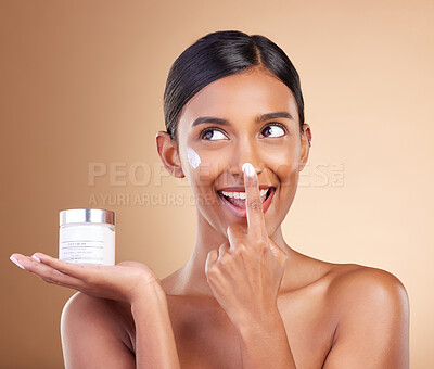 Buy stock photo Woman, face and applying moisturizer cream for beauty skincare cosmetics, self love or care against a studio background. Happy female with smile for lotion, moisturizing creme or facial treatment