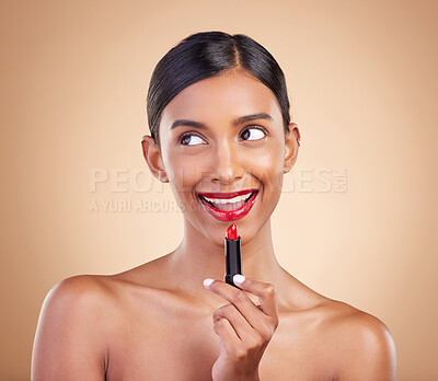 Buy stock photo Makeup, red lipstick and beauty of a woman in studio for cosmetics, face glow and shine product. Indian female model thinking on beige background about skin, facial self care and lips with color idea