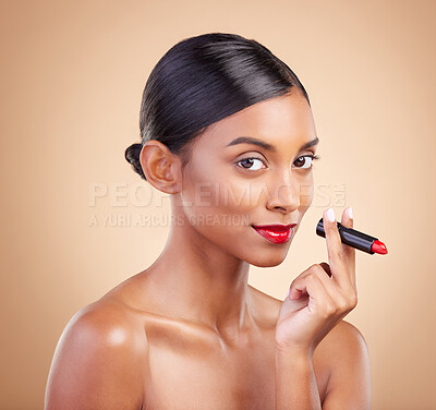 Buy stock photo Portrait, skincare and Indian woman with lipstick, beauty and happy against brown studio background. Face, female and lady with makeup, cosmetics and red gloss with confidence, aesthetic and glowing