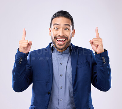 Buy stock photo Excited man, business and pointing hands at space in studio for motivation and advertising. Asian male and happy model portrait on gray background with fingers up for mockup promotion announcement