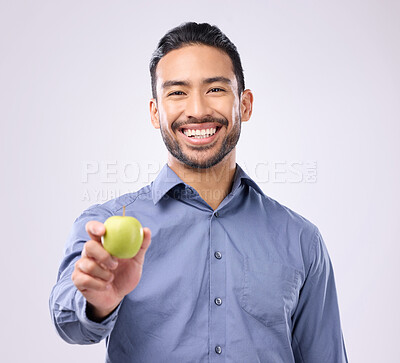 Buy stock photo Apple, portrait and man happy with fruit for weight loss diet, studio healthcare or body detox. Wellness food, nutritionist lifestyle person and male vegan giving product isolated on gray background