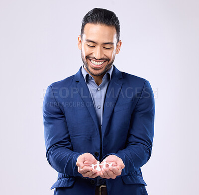 Buy stock photo Insurance, trust and financial security with a business man holding a paper cutout of a family on a studio gray background. Future, safety and life cover with a handsome young male broker or agent