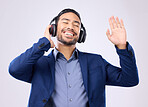 Business man, headphones and dancing on studio background for happiness, motivation and inspiration. Happy corporate worker, dance music and listening to radio sound, relaxing audio podcast and smile