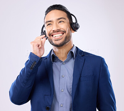 Buy stock photo Thinking, customer service and smile with a man consulting using a headset for support in studio on a gray background. Idea, contact us and crm with a happy male consultant talking over a microphone