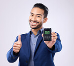 Business man, pos and studio portrait with thumbs up, fintech or payment security by grey background. Asian entrepreneur, sales expert and digital machine for purchase, buying or money with happiness