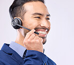 Call center, headset and happy man isolated on a white background for telemarketing, telecom or global support. Asian international agent, consultant or business person for virtual salesman in studio