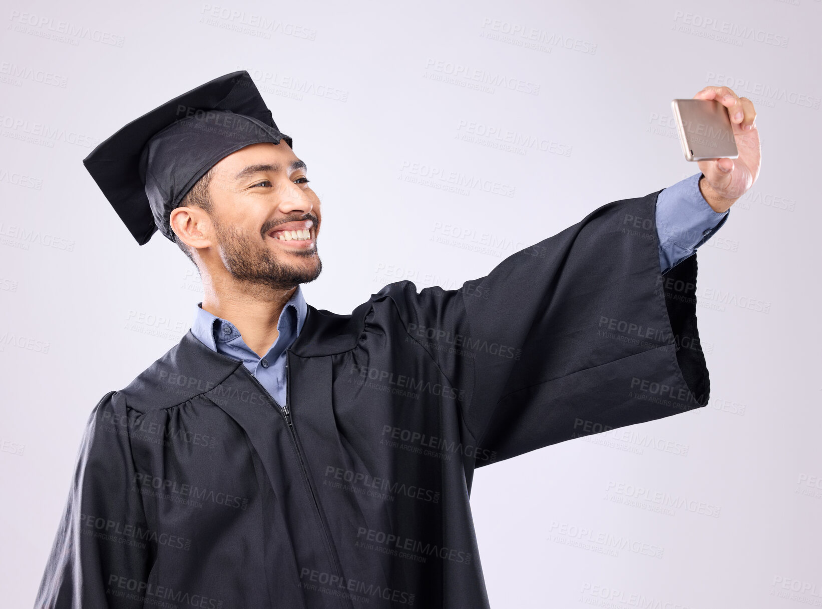 Buy stock photo Man, graduate and selfie with smile for scholarship, profile picture or social media against a gray studio background. Happy excited male academic smiling for graduation photo, memory or online post