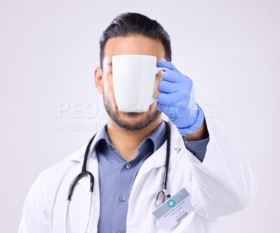 Buy stock photo Hand, coffee and break with doctor man in studio on a gray background for a drink to start his morning. Medical, healthcare and beverage with a medicine professional holding a cup or mug for tea