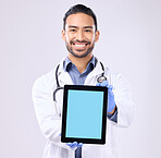 Tablet mockup and doctor portrait isolated on a white background technology green screen for telehealth service. Medical professional or healthcare asian man with digital app mock up space in studio