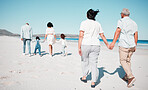 Senior couple, holding hands and family at beach with back for walk, freedom and vacation together with love. Old man, woman and grandchildren by ocean for walking, wellness and adventure in sunshine