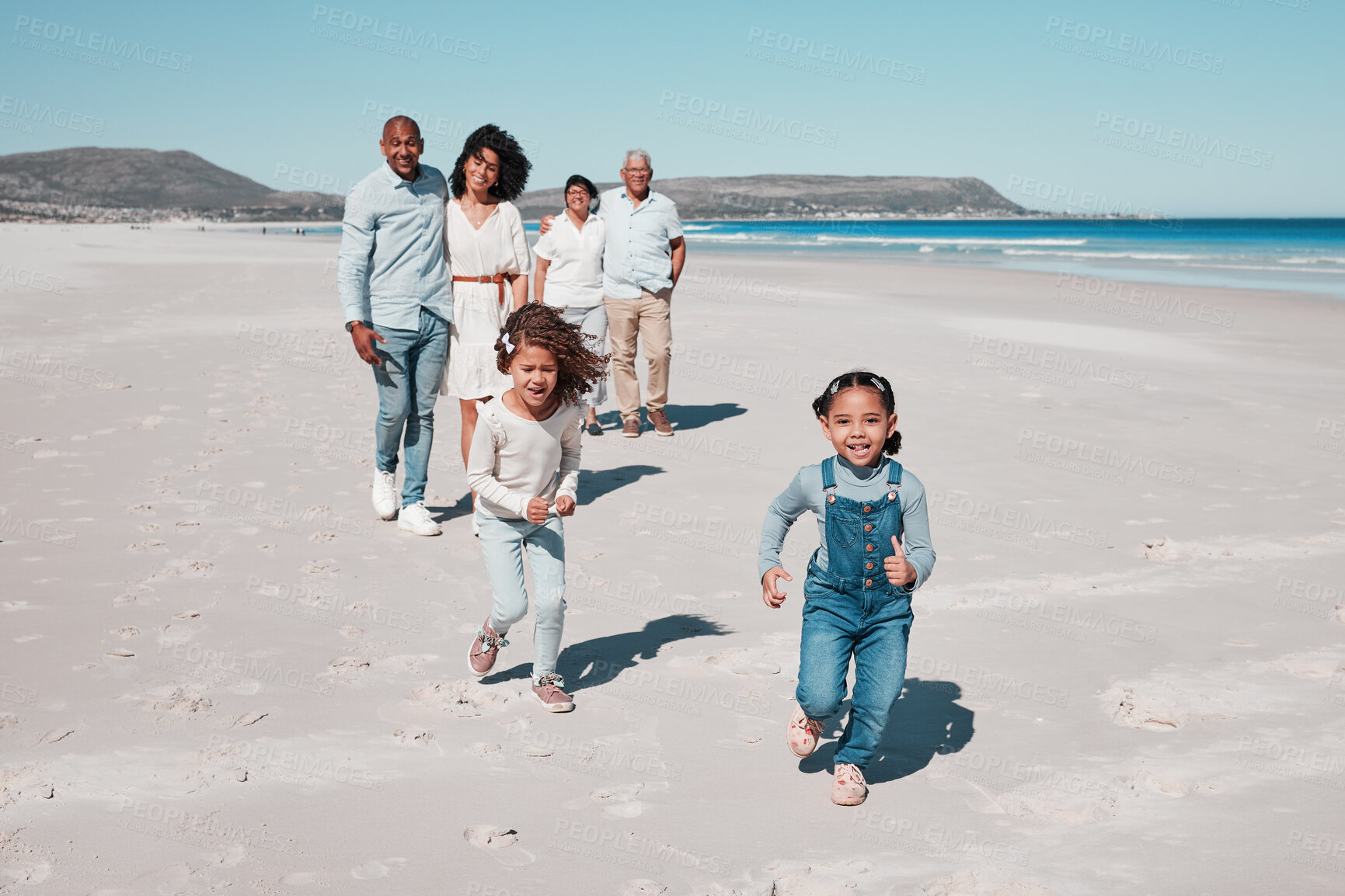 Buy stock photo Beach, family and portrait of kids running in sand, playful and having fun while bonding outdoors. Face, children and parents with grandparents on summer vacation at sea on ocean trip in Cape town